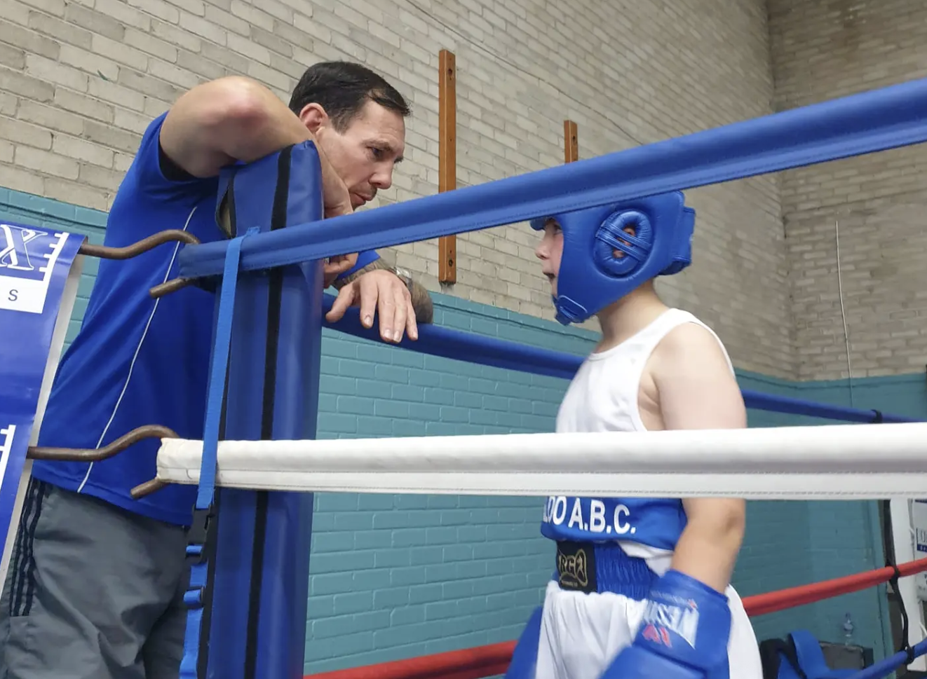 Coach giving corner advice to a young boxer at Waterloo ABC